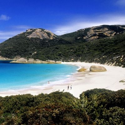 Two people walking on beach near Albany