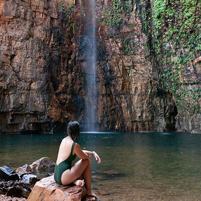 Travel Nurse in Kununurra Australia by waterfall.